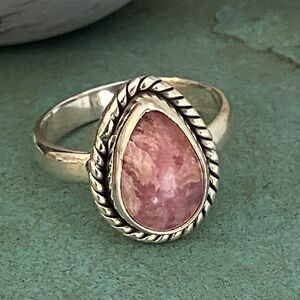 Genuine pink stone on sterling silver ring.